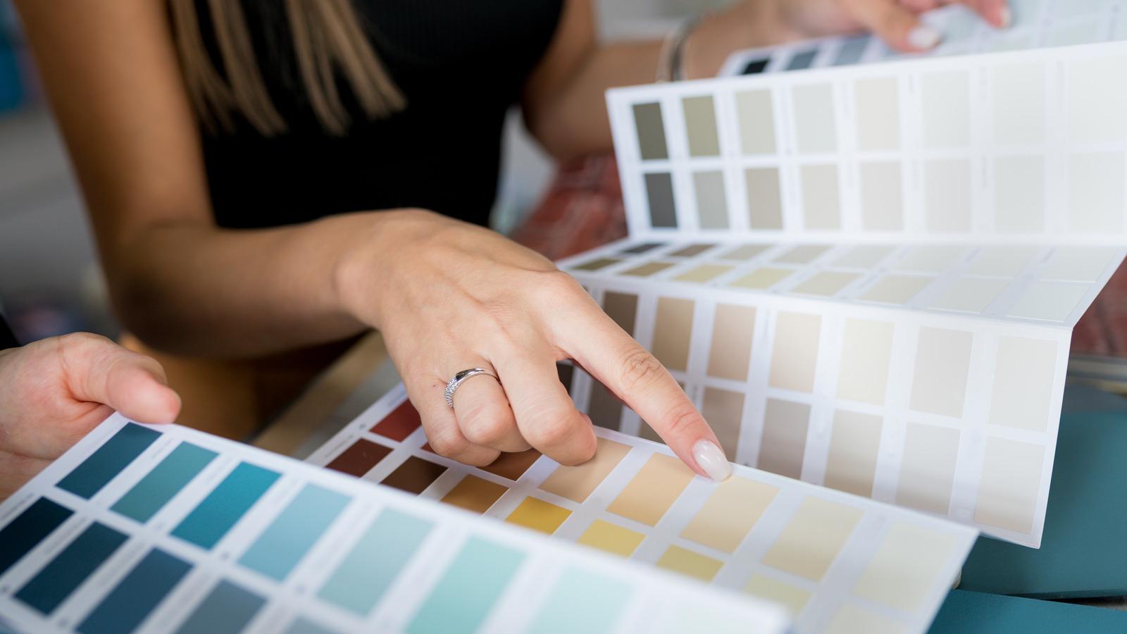 Close-up,Of,Two,Women,Choosing,Samples,Of,Wall,Paint.,Interior